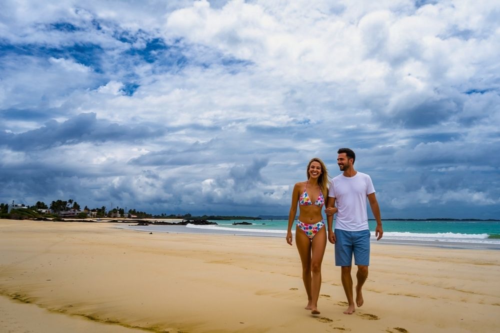 Couple walking on a sandy beach at Puerto Villamil during a luxury Galápagos and mainland ecuador vacation trip