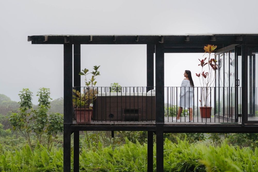 Guest in bathrobe on a jacuzzi deck at Scalesia Lodge on Isabela Island during a Galápagos three islands luxury tour