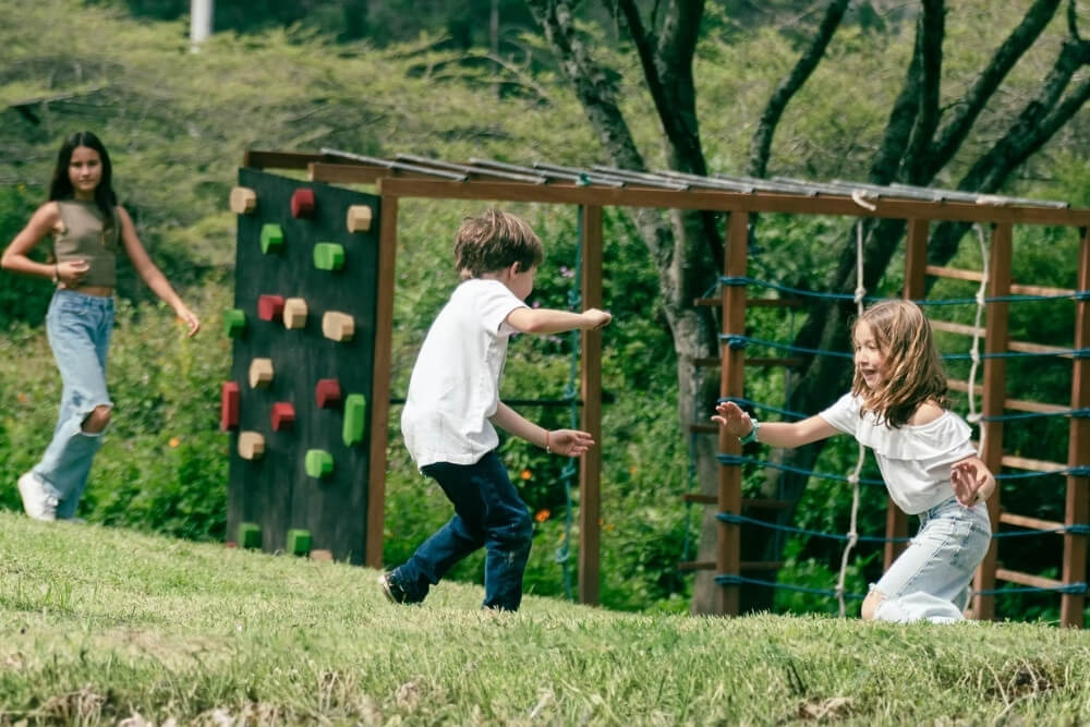 children playing in the outdoor play zone at la capricciosa restaurant in tumbaco
