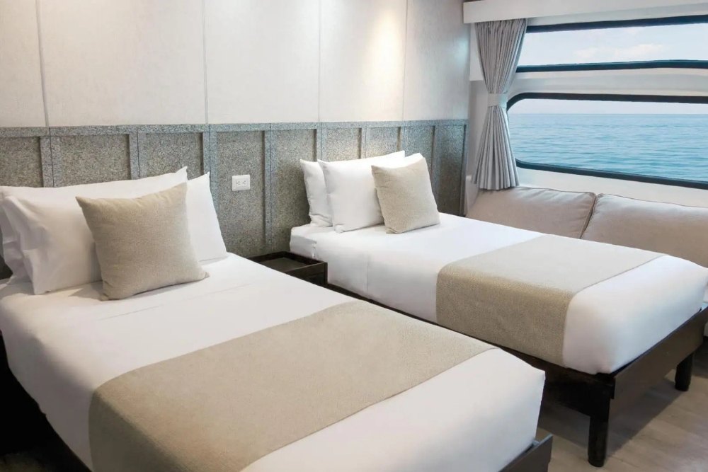 Two cozy beds in a suite of the EcoGalaxy Cruise