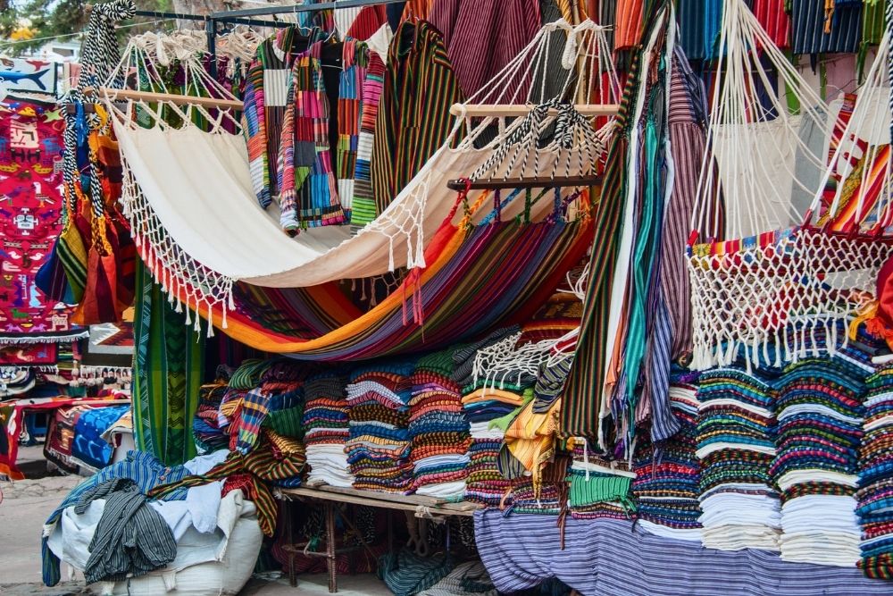 Colorful handwoven hammocks and textiles crafted by the otavalo kichwa community on display at the Otavalo Market