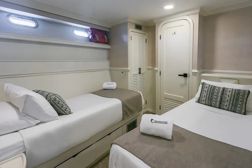 Two beds arranged at the deluxe suite of the Galapagos Sky
