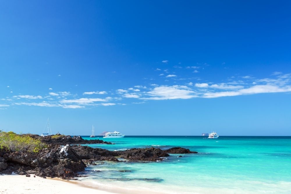 las bachas beach on santa cruz island, with boats