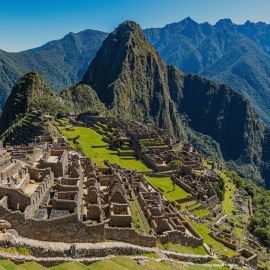 view of machu picchu and the ancient ruins over the mountain.