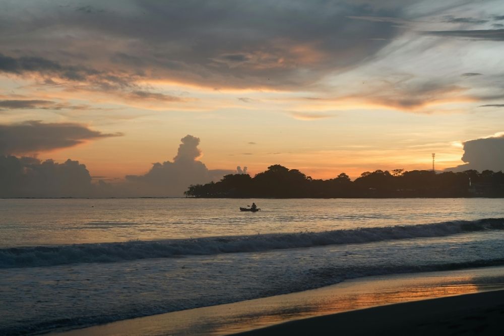 Kayak paddling on calm coastal waters at sunset in Cahuita National Park during an unforgettable latin america expedition