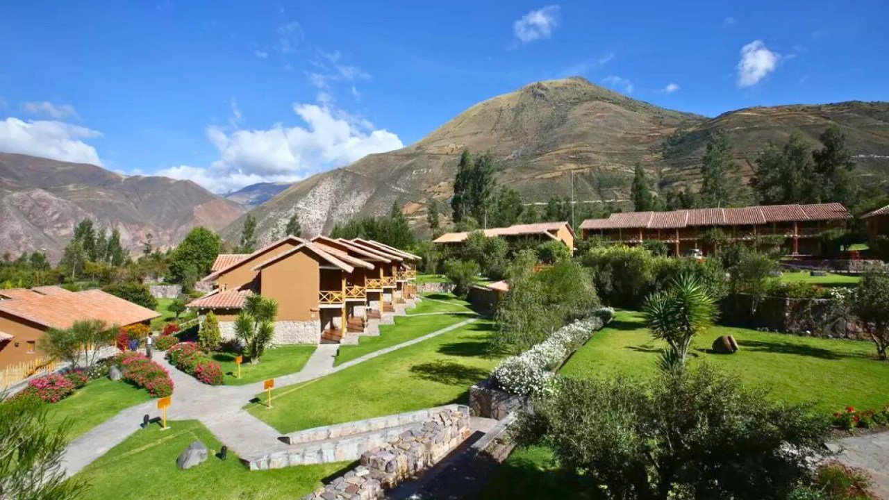 Panoramic view of Casa Andina Premium Sacred Valley surrounded by green gardens and mountains