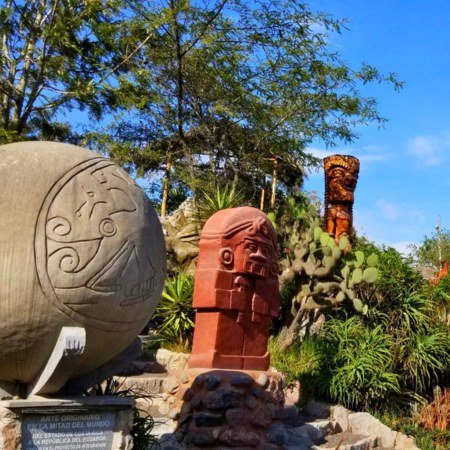 intinan-museum-ecuador Rebecca Adventure Travel Carved stone indigenous totems and equatorial sphere exhibit surrounded by greenery at Intiñan Museum in Ecuador