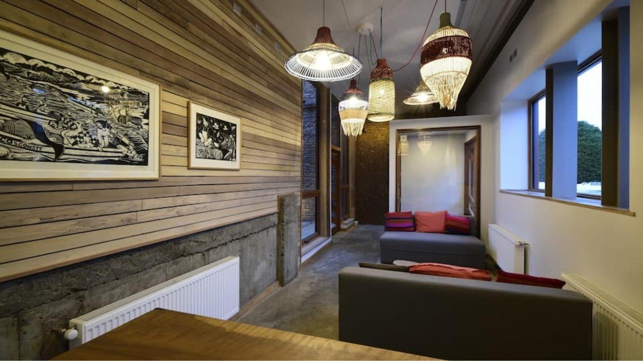 Stylish lounge area with warm timber walls and pendant lights at Hotel Vendaval in Puerto Natales Chilean Patagonia