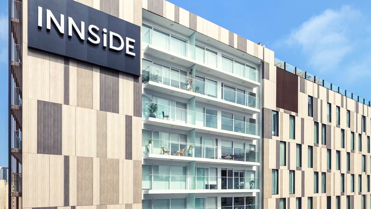 Modern exterior façade and bold prominent signage of the stylish Innside Miraflores hotel set under a clear blue sky