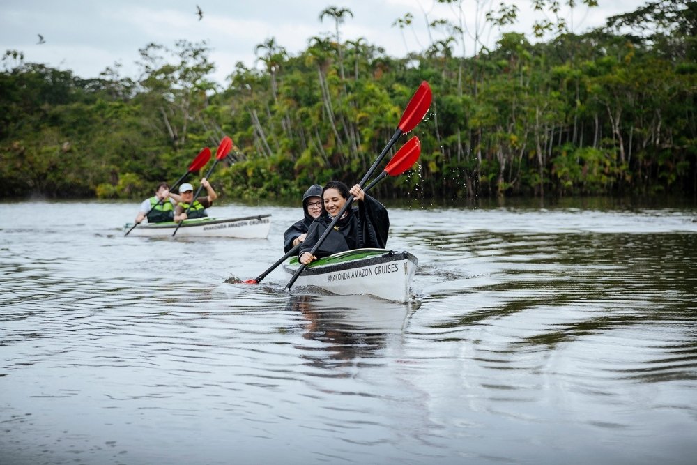 travelers kayaking on a river in the amazon