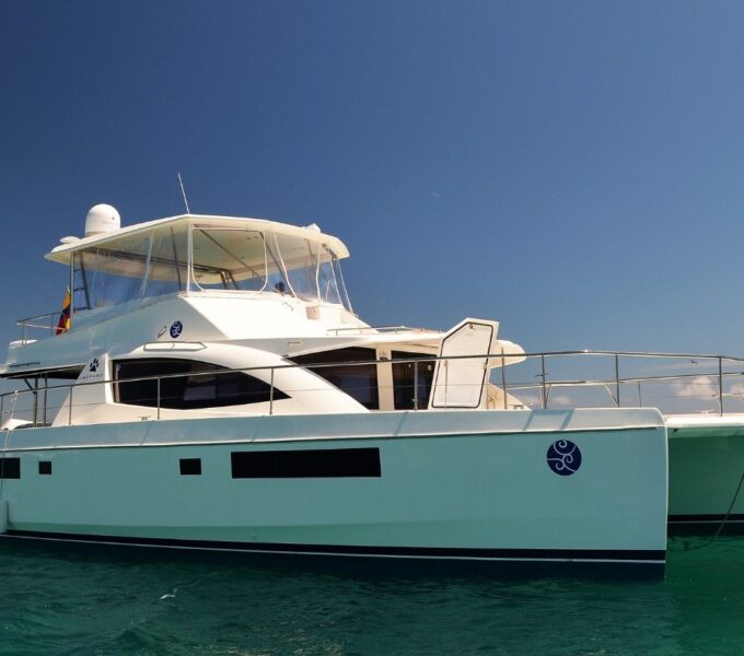 luxury catamaran used for inter-island transportation in galapagos cruising between islands on clear turquoise water