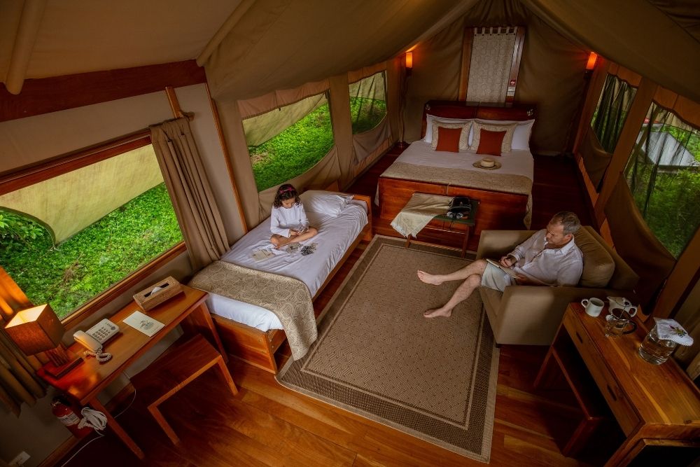 family relaxing inside a luxury safari tent at galapagos safari camp