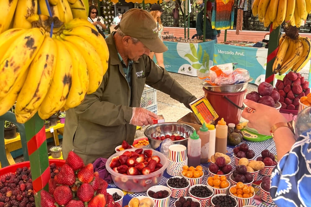 colorful fruit market stand in medellín, showcasing local produce and colombian biodiversity celebrated at the flower festival