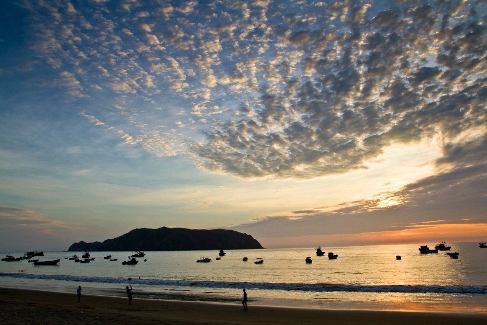 sunset view of salango island surrounded by the fishing boats.